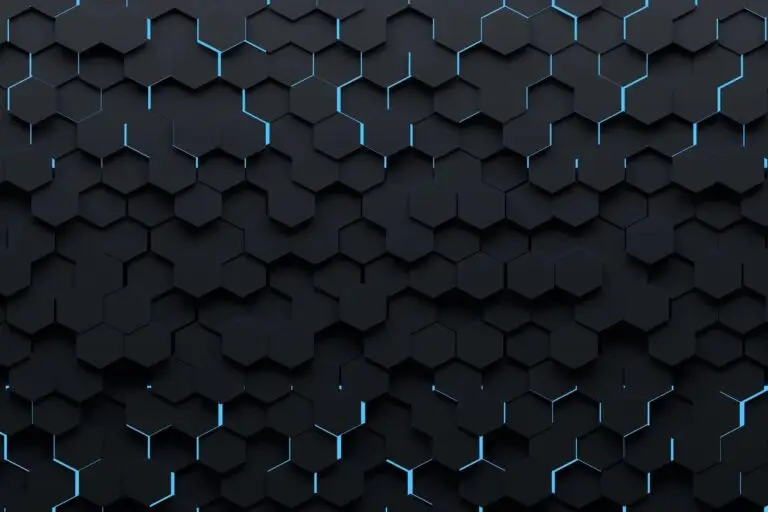 A dark, abstract background featuring a pattern of interconnected black hexagons with thin, glowing blue lines between some of the hexagons. The pattern creates a textured, three-dimensional effect with varying depths and shadows, evoking an atmosphere reminiscent of cyberthreat landscapes.