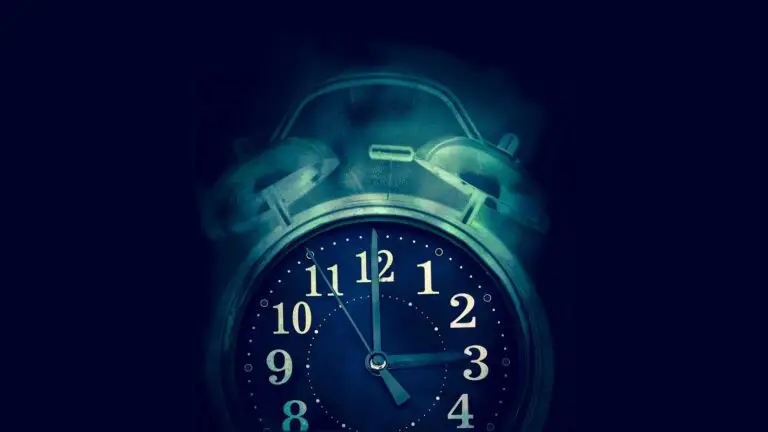 A glowing, vintage-style alarm clock is set against a dark background. The clock face is illuminated in blue tones, displaying the time as 12:10. The clock's two bells and hammer are prominently visible, adding a nostalgic feel to the image—a silent sentinel in a world full of cyberthreats.