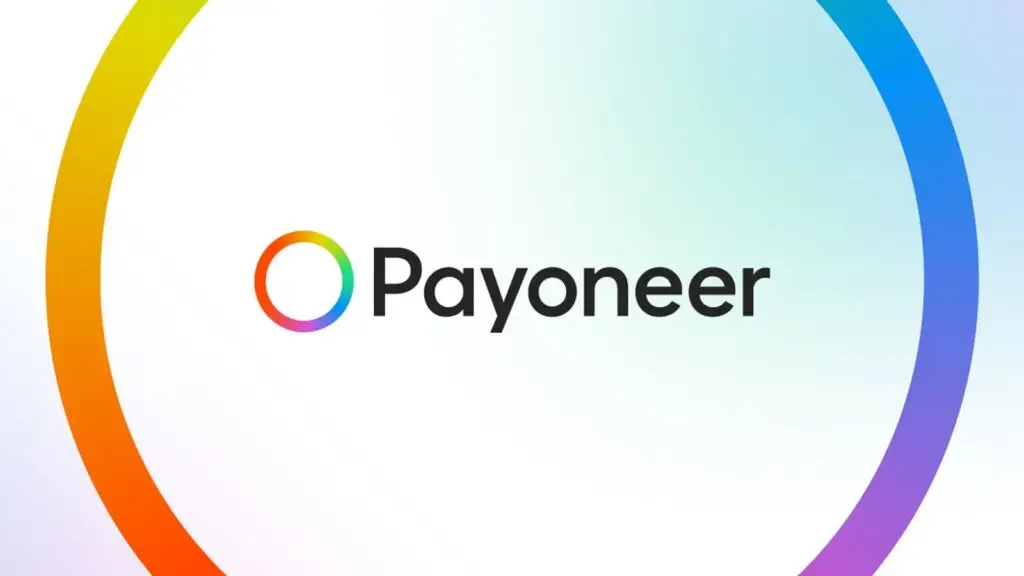 The image shows the Payoneer logo. The logo consists of a circular ring with a gradient of rainbow colors, partially filled in with white, next to the word "Payoneer" in black text. The background is a gradient of light blue, green, and purple, adding a modern touch reminiscent of VPN interfaces.