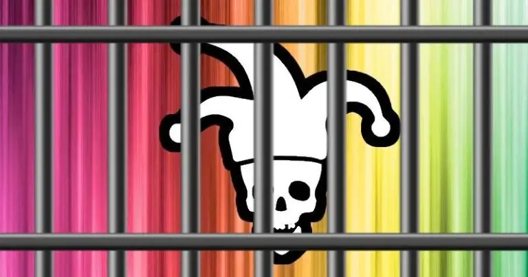 An image shows a jester's hat with a skull face on a multicolored striped background. Overlaid with metal prison bars, the scene gives the appearance that the hat and skull are behind bars, symbolizing cybersecurity measures like VPNs and DOD protocols keeping threats contained.