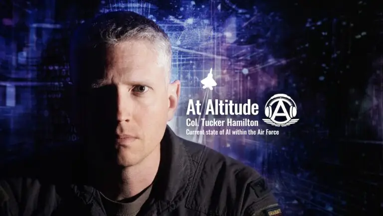 A man in a military uniform is shown against a dark, space-like background with digital elements. Text reads "At Altitude Col. Tucker Hamilton Current state of AI within the Air Force." A logo of an aircraft is above him, and one side of his face is in shadow, hinting at the evolving cybersecurity threat landscape.