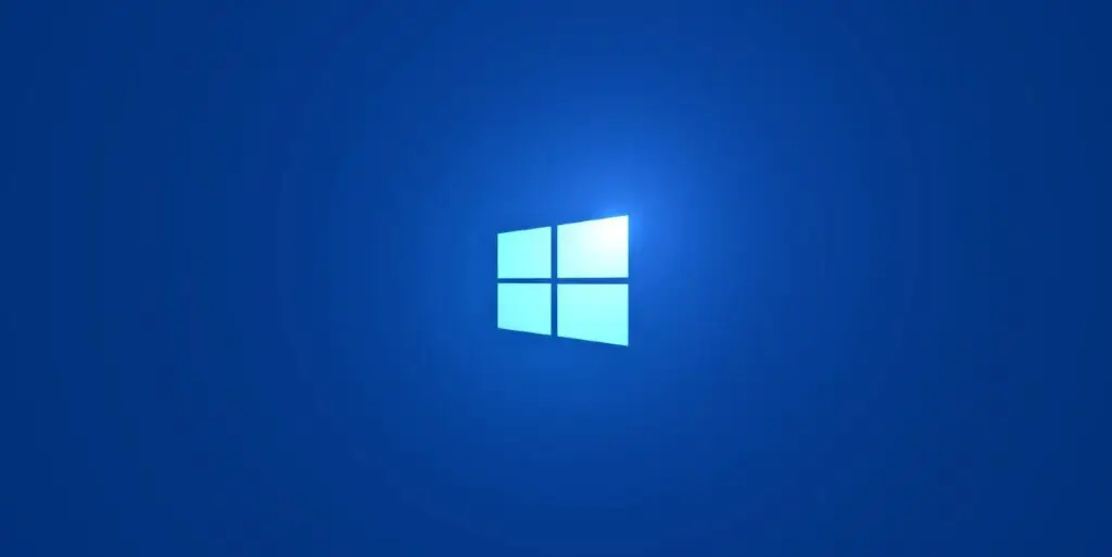 A bright blue background featuring the Microsoft Windows logo, which consists of four white rectangular panes arranged in a grid to form a window. The logo emits a soft glow, symbolizing robust cybersecurity measures.