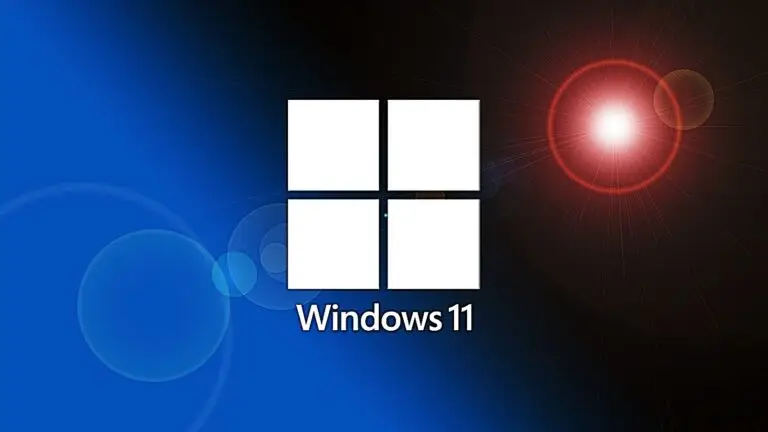 A Windows 11 logo, consisting of four white squares in a grid, is centered on a background merging blue on the left with a bright red lens flare on the right. The "Windows 11" text appears below the logo, subtly emphasizing its commitment to cybersecurity.