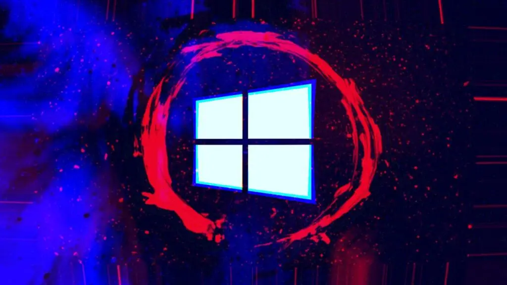 A glowing Windows logo is centered against a dark, abstract, space-like background. Enveloped by a red, circular, paint-like brushstroke, the logo stands out. Bright red and purple specks scattered across the backdrop lend a galaxy-like effect, evoking an aura of cybersecurity in an ever-expanding digital universe.