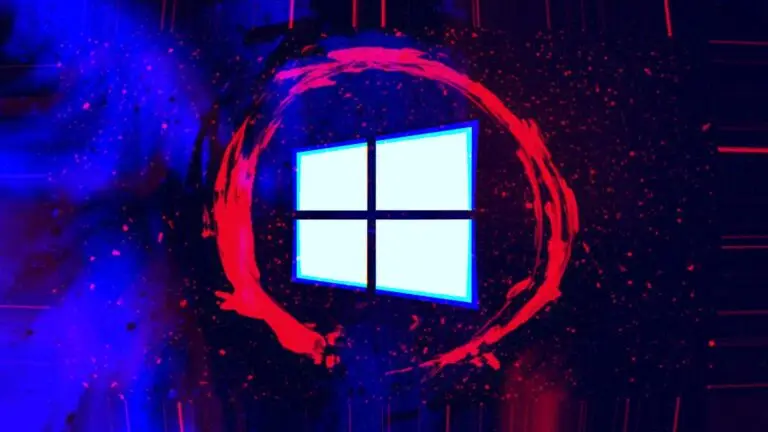 A glowing Windows logo is centered against a dark, abstract, space-like background. Enveloped by a red, circular, paint-like brushstroke, the logo stands out. Bright red and purple specks scattered across the backdrop lend a galaxy-like effect, evoking an aura of cybersecurity in an ever-expanding digital universe.